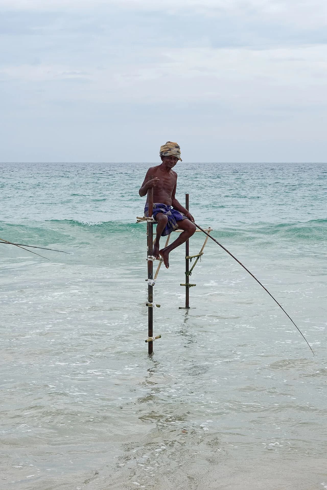 Koggala - Fisherman practicing traditional stilt fishing in Koggala near Galle, southern Sri Lanka