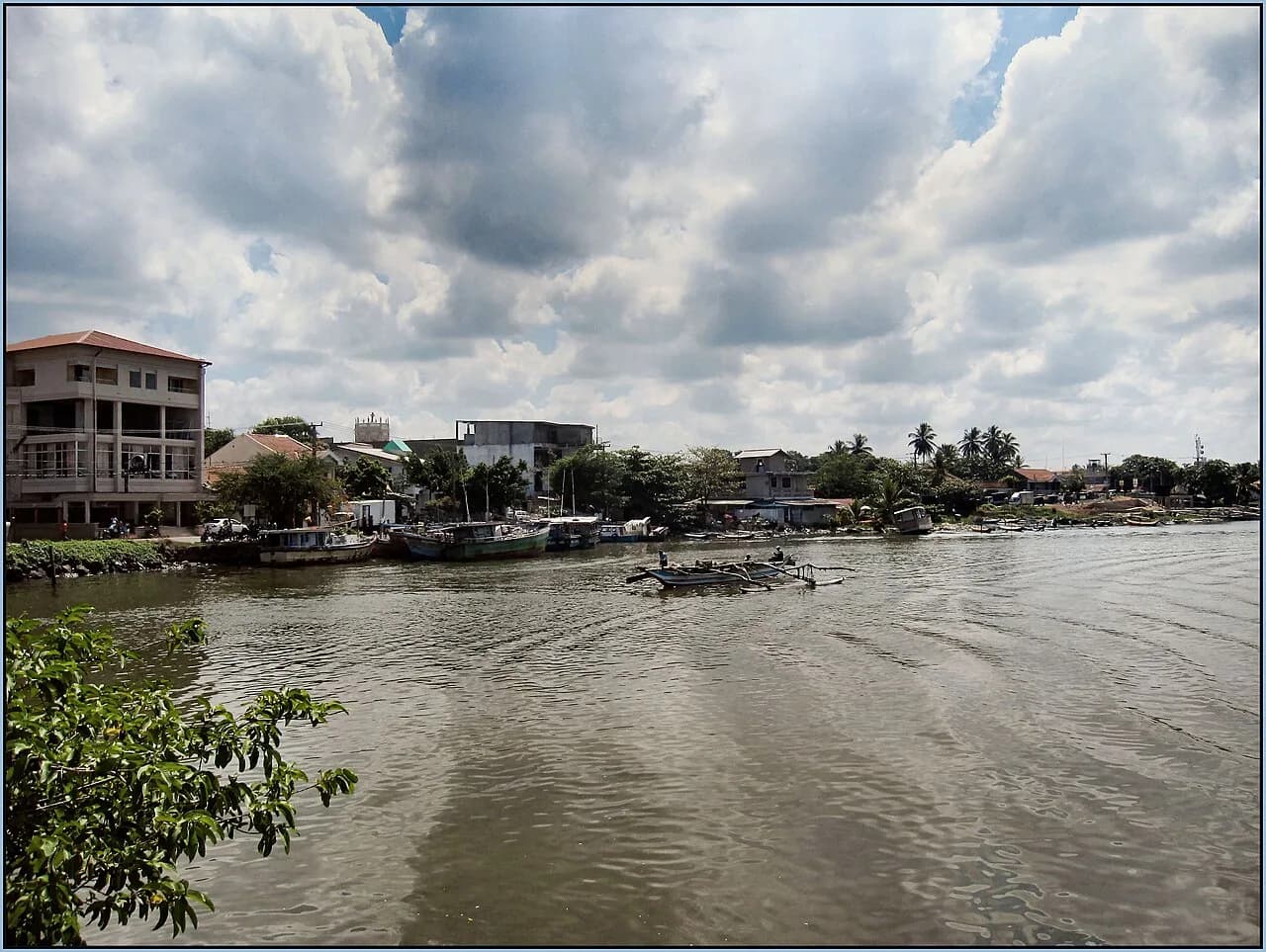 Negombo - This two hulled vessel is heading out from the lagoon in Negombo.Dark overcast day. More rain on the way again.